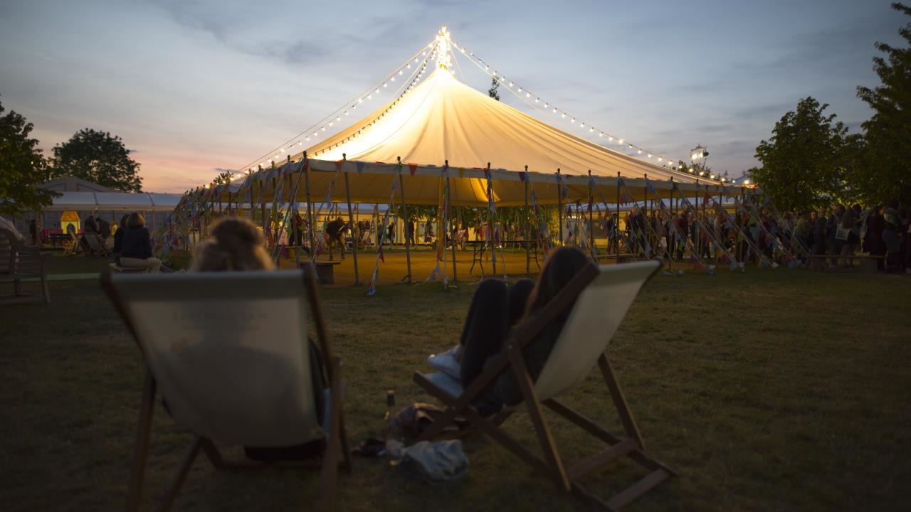 Hay Festival tents lit at twilight